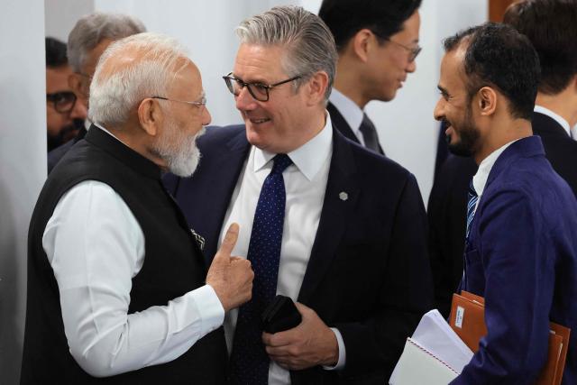 India's Prime Minister Narendra Modi(L) speaks with Britain's Prime Minister Keir Starmer a morning work meeting to “revive balanced, inclusive, and sustainable economic growth for the benefit of all” in the presence of the G7 countries, partner countries, the International Monetary Fund, and the OECD, as part of the G7 summit, in Evian, eastern France, on June 17, 2026. G7 leaders will discuss on June 17, 2026, the security risks posed by AI and social media on the last day of a summit dominated by US the President, before host French President  dines with his US counterpart at the Palace of Versailles. The three-day summit of the leaders of Canada, France, Germany, Italy, Japan,B ritain and the United States has focused intensely on the US' deal to end the war with Iran and efforts to pressure Russia into brokering peace with Ukraine. (Photo by Ludovic MARIN / AFP)