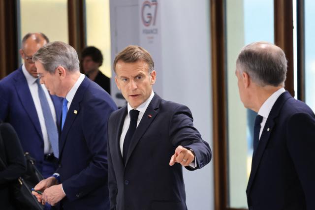 France's President Emmanuel Macron arrives to attend a morning work meeting to “revive balanced, inclusive, and sustainable economic growth for the benefit of all” in the presence of the G7 countries, partner countries, the International Monetary Fund, and the OECD, as part of the G7 summit, in Evian, eastern France, on June 17, 2026. G7 leaders will discuss on June 17, 2026, the security risks posed by AI and social media on the last day of a summit dominated by US the President, before host French President  dines with his US counterpart at the Palace of Versailles. The three-day summit of the leaders of Canada, France, Germany, Italy, Japan,B ritain and the United States has focused intensely on the US' deal to end the war with Iran and efforts to pressure Russia into brokering peace with Ukraine. (Photo by Ludovic MARIN / AFP)