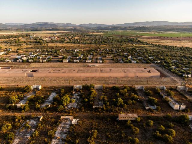 This aerial view shows The Rivesaltes Camp Memorial and The Joffre Camp site at Salses Le Chateau in the Pyrenees-Orientales department in south-western France on June 17, 2026. Bearing painful memories, the museum of the Rivesaltes camp (Pyrйnйes-Orientales) — which over the course of the 20th century housed Spanish refugees, Jews, Roma and Harkis — has unveiled a new permanent exhibition, was inaugurated on May 29, 2026, to defend “historical truth” against the “populisms” that threaten it. (Photo by Jc Milhet / AFP)
