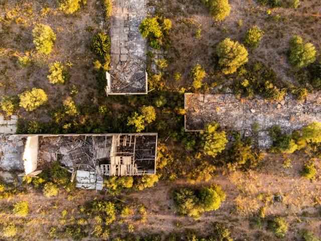 This aerial view shows The Rivesaltes Camp Memorial and The Joffre Camp site at Salses Le Chateau in the Pyrenees-Orientales department in south-western France on June 17, 2026. Bearing painful memories, the museum of the Rivesaltes camp (Pyrйnйes-Orientales) — which over the course of the 20th century housed Spanish refugees, Jews, Roma and Harkis — has unveiled a new permanent exhibition, was inaugurated on May 29, 2026, to defend “historical truth” against the “populisms” that threaten it. (Photo by Jc Milhet / AFP)