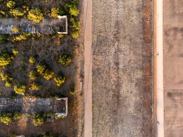 This aerial view shows The Rivesaltes Camp Memorial and The Joffre Camp site at Salses Le Chateau in the Pyrenees-Orientales department in south-western France on June 17, 2026. Bearing painful memories, the museum of the Rivesaltes camp (Pyrйnйes-Orientales) — which over the course of the 20th century housed Spanish refugees, Jews, Roma and Harkis — has unveiled a new permanent exhibition, was inaugurated on May 29, 2026, to defend “historical truth” against the “populisms” that threaten it. (Photo by Jc Milhet / AFP)