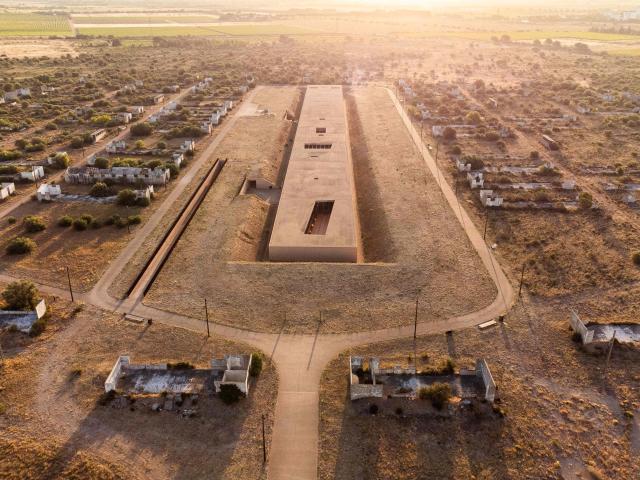 This aerial view shows The Rivesaltes Camp Memorial and The Joffre Camp site at Salses Le Chateau in the Pyrenees-Orientales department in south-western France on June 17, 2026. Bearing painful memories, the museum of the Rivesaltes camp (Pyrйnйes-Orientales) — which over the course of the 20th century housed Spanish refugees, Jews, Roma and Harkis — has unveiled a new permanent exhibition, was inaugurated on May 29, 2026, to defend “historical truth” against the “populisms” that threaten it. (Photo by Jc Milhet / AFP)