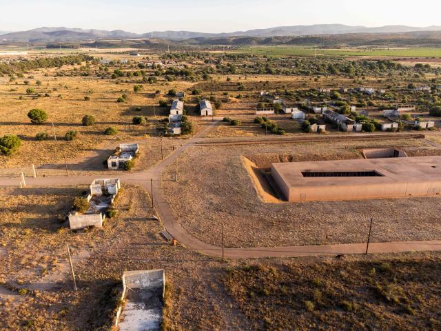 This aerial view shows The Rivesaltes Camp Memorial and The Joffre Camp site at Salses Le Chateau in the Pyrenees-Orientales department in south-western France on June 17, 2026. Bearing painful memories, the museum of the Rivesaltes camp (Pyrйnйes-Orientales) — which over the course of the 20th century housed Spanish refugees, Jews, Roma and Harkis — has unveiled a new permanent exhibition, was inaugurated on May 29, 2026, to defend “historical truth” against the “populisms” that threaten it. (Photo by Jc Milhet / AFP)