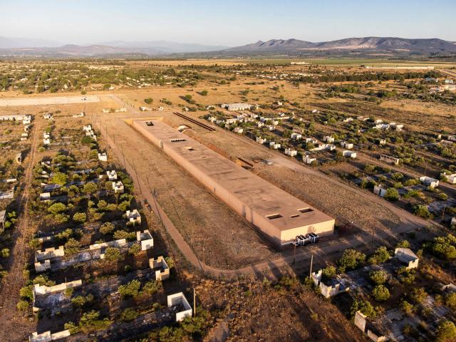This aerial view shows The Rivesaltes Camp Memorial and The Joffre Camp site at Salses Le Chateau in the Pyrenees-Orientales department in south-western France on June 17, 2026. Bearing painful memories, the museum of the Rivesaltes camp (Pyrйnйes-Orientales) — which over the course of the 20th century housed Spanish refugees, Jews, Roma and Harkis — has unveiled a new permanent exhibition, was inaugurated on May 29, 2026, to defend “historical truth” against the “populisms” that threaten it. (Photo by Jc Milhet / AFP)