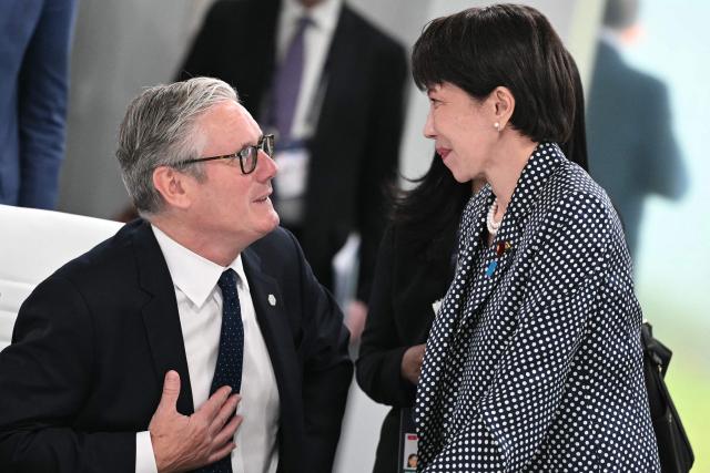 Britain's Prime Minister Keir Starmer (L) speaks with Japan's Prime Minister Sanae Takaichi ahead of a morning work meeting to “revive balanced, inclusive, and sustainable economic growth for the benefit of all” in the presence of the G7 countries, partner countries, the International Monetary Fund, and the OECD, as part of the G7 summit, in Evian, eastern France, on June 17, 2026. G7 leaders will discuss on June 17, 2026, the security risks posed by AI and social media on the last day of a summit dominated by US the President, before host French President  dines with his US counterpart at the Palace of Versailles. The three-day summit of the leaders of Canada, France, Germany, Italy, Japan,B ritain and the United States has focused intensely on the US' deal to end the war with Iran and efforts to pressure Russia into brokering peace with Ukraine. (Photo by Mandel NGAN / POOL / AFP)
