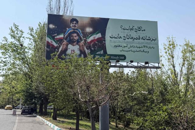 A billboard showing an image of Iran's 2026 World Cup team forward #09 Mehdi Taremi, posted on a highway in Tehran on June 17, 2026. The first tankers carrying Iranian oil exited a US blockade in the Strait of Hormuz, a tracking website said on June 17, two days before Washington and Tehran launch talks on an agreed peace deal still scant on details -- including Iran's nuclear programme and the lifting of sanctions. (Photo by ATTA KENARE / AFP) / 