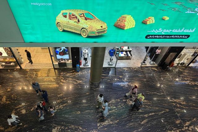 Iranians visit a large shopping mall in the capital Tehran on June 17, 2026. The first tankers carrying Iranian oil exited a US blockade in the Strait of Hormuz, a tracking website said on June 17, two days before Washington and Tehran launch talks on an agreed peace deal still scant on details -- including Iran's nuclear programme and the lifting of sanctions. (Photo by ATTA KENARE / AFP) / 