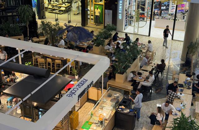 Customers sits at a coffee shop come restaurant as Iranians visit a large shopping mall in the capital Tehran on June 17, 2026. The first tankers carrying Iranian oil exited a US blockade in the Strait of Hormuz, a tracking website said on June 17, two days before Washington and Tehran launch talks on an agreed peace deal still scant on details -- including Iran's nuclear programme and the lifting of sanctions. (Photo by ATTA KENARE / AFP) / 