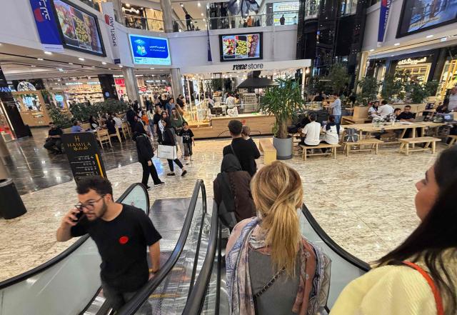 Iranians visit a large shopping mall in the capital Tehran on June 17, 2026. The first tankers carrying Iranian oil exited a US blockade in the Strait of Hormuz, a tracking website said on June 17, two days before Washington and Tehran launch talks on an agreed peace deal still scant on details -- including Iran's nuclear programme and the lifting of sanctions. (Photo by ATTA KENARE / AFP) / 