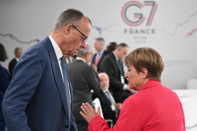 Germany’s Chancellor Friedrich Merz (L) speaks with IMF Managing Director Kristalina Georgieva ahead of a morning work meeting to “revive balanced, inclusive, and sustainable economic growth for the benefit of all” in the presence of the G7 countries, partner countries, the International Monetary Fund, and the OECD, as part of the G7 summit, in Evian, eastern France, on June 17, 2026. G7 leaders will discuss on June 17, 2026, the security risks posed by AI and social media on the last day of a summit dominated by US the President, before host French President  dines with his US counterpart at the Palace of Versailles. The three-day summit of the leaders of Canada, France, Germany, Italy, Japan,B ritain and the United States has focused intensely on the US' deal to end the war with Iran and efforts to pressure Russia into brokering peace with Ukraine. (Photo by Mandel NGAN / POOL / AFP)