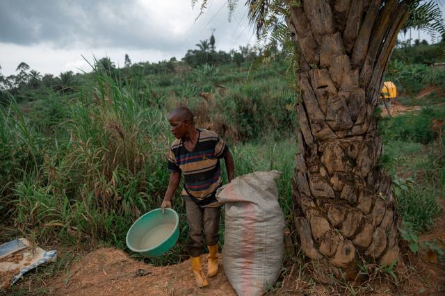 A miner dries gravel containing traces of gold under the sun at an artisanal mine in Mongbwalu, Ituri province, on June 16, 2026. The latest Ebola outbreak in the Democratic Republic of the Congo, declared on May 15, 2026, has mainly affected the remote, conflict-weary northeastern province of Ituri. Health officials warn that population movements linked to artisanal mining, displacement and insecurity are hampering containment efforts in a region where no approved vaccine exists for this Ebola strain. (Photo by Jospin Mwisha / AFP)