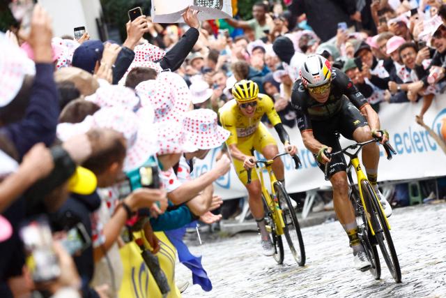 (FILES) Team Visma - Lease a bike team's Belgian rider Wout van Aert (R) cycles ahead of UAE Team Emirates - XRG team's Slovenian rider Tadej Pogacar wearing the overall leader's yellow jersey up Rue Lepic on the Butte de Montmartre during the 21st and final stage of the 112th edition of the Tour de France cycling race, 132.3 km between Mantes-la-Ville and Paris' Champs-Elysees Avenue, on July 27, 2025. Belgian rider Wout van Aert will miss the Tour de France with an elbow injury, his Visma team announced on June 17, 2026. "The Belgian is still dealing with the effects of an elbow injury and has not recovered in time to start the Tour de France at the required level," the team said. (Photo by Etienne GARNIER / POOL / AFP)