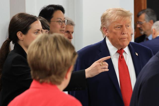 US President Donald Trump (R) arrives to attend a morning work meeting to “revive balanced, inclusive, and sustainable economic growth for the benefit of all” in the presence of the G7 countries, partner countries, the International Monetary Fund, and the OECD, as part of the G7 summit, in Evian, eastern France, on June 17, 2026. G7 leaders will discuss on June 17, 2026, the security risks posed by AI and social media on the last day of a summit dominated by US the President, before host French President  dines with his US counterpart at the Palace of Versailles. The three-day summit of the leaders of Canada, France, Germany, Italy, Japan,B ritain and the United States has focused intensely on the US' deal to end the war with Iran and efforts to pressure Russia into brokering peace with Ukraine. (Photo by Ludovic MARIN / AFP)