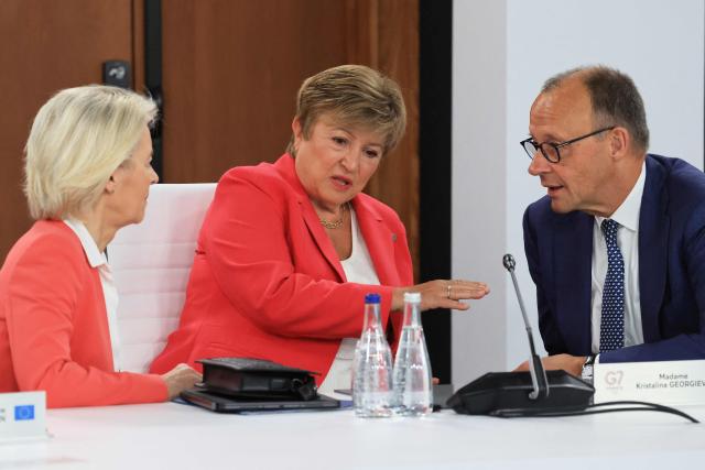European Commission President Ursula von der Leyen (L), IMF Managing Director Kristalina Georgieva and Germany’s Chancellor Friedrich Merz speak together ahead of a morning work meeting to “revive balanced, inclusive, and sustainable economic growth for the benefit of all” in the presence of the G7 countries, partner countries, the International Monetary Fund, and the OECD, as part of the G7 summit, in Evian, eastern France, on June 17, 2026. G7 leaders will discuss on June 17, 2026, the security risks posed by AI and social media on the last day of a summit dominated by US the President, before host French President  dines with his US counterpart at the Palace of Versailles. The three-day summit of the leaders of Canada, France, Germany, Italy, Japan,B ritain and the United States has focused intensely on the US' deal to end the war with Iran and efforts to pressure Russia into brokering peace with Ukraine. (Photo by Ludovic MARIN / AFP)