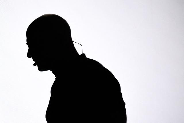 TOPSHOT - This photograph shows the silhouette of US Amazon's founder Jeff Bezos on stage at the VivaTech technology startups and innovation fair at the Paris Expo Porte de Versailles, in Paris on June 17, 2026. (Photo by JULIEN DE ROSA / AFP)