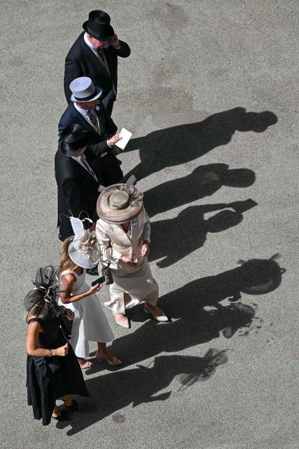 Racegoers arrive on the second day of the Royal Ascot horse racing meeting in Ascot, west of London, on June 17, 2026. (Photo by JUSTIN TALLIS / AFP)