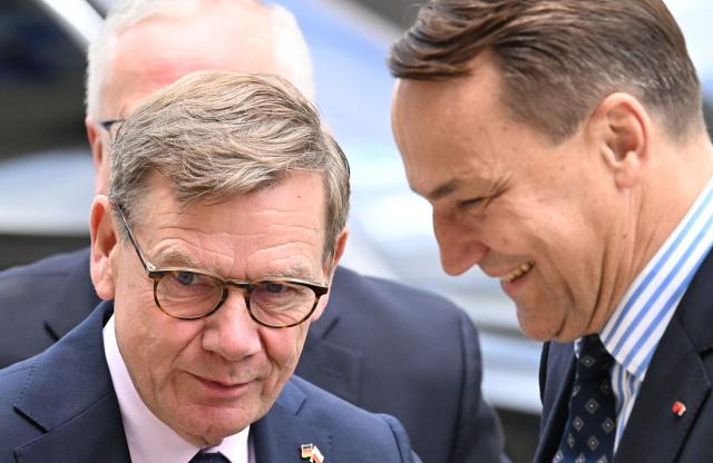 German Foreign Minister Johann Wadephul (L) welcomes Polish Foreign Minister Radoslaw Sikorski as he arrives for the German-Polish Forum at the Foreign Ministry in Berlin on June 17, 2026. Key elements of this year's forum include the presentation of the German-Polish Prize, the return of several cultural artifacts by Germany to Poland’s Minister of Culture and working groups to discuss topics such as Europe, security, culture, youth, history, the economy, and language. (Photo by RALF HIRSCHBERGER / AFP)