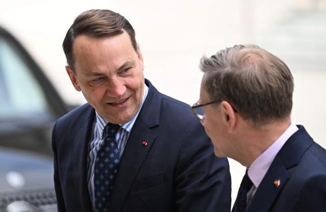 German Foreign Minister Johann Wadephul (R) welcomes Polish Foreign Minister Radoslaw Sikorski as he arrives for the German-Polish Forum at the Foreign Ministry in Berlin on June 17, 2026. Key elements of this year's forum include the presentation of the German-Polish Prize, the return of several cultural artifacts by Germany to Poland’s Minister of Culture and working groups to discuss topics such as Europe, security, culture, youth, history, the economy, and language. (Photo by RALF HIRSCHBERGER / AFP)