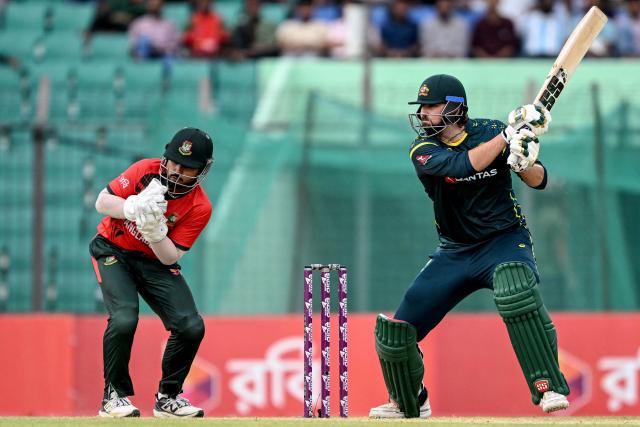 Australia's Tim David (R) plays a shot during the first Twenty20 (T20) international cricket match between Bangladesh and Australia at the Bir Sreshtho Flight Lieutenant Matiur Rahman Stadium in Chattogram on June 17, 2026. (Photo by AFP)
