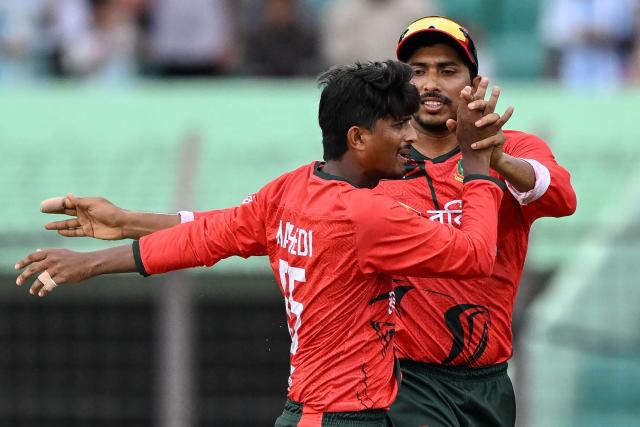 Bangladesh's Mahedi Hasan (L) celebrates with a teammate after taking the wicket of Australia's Tim David during the first Twenty20 (T20) international cricket match between Bangladesh and Australia at the Bir Sreshtho Flight Lieutenant Matiur Rahman Stadium in Chattogram on June 17, 2026. (Photo by AFP)
