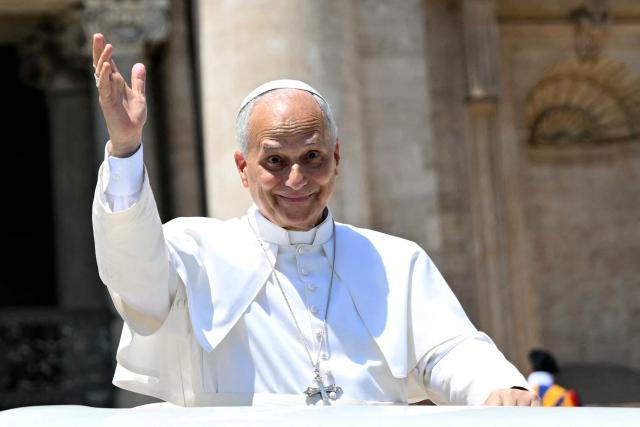 Pope Leo XIV waves to the crowd at the end of the weekly general audience at St Peter's Square in The Vatican on May 17, 2026. (Photo by Andreas SOLARO / AFP)