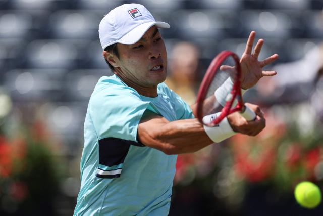 Brandon Nakashima of the US hits a return against Peru's Ignacio Buse during their men's singles round of 16 tennis match on day three of the ATP HSBC Championships at Queen's Club in west London on June 17, 2026. (Photo by Adrian Dennis / AFP)