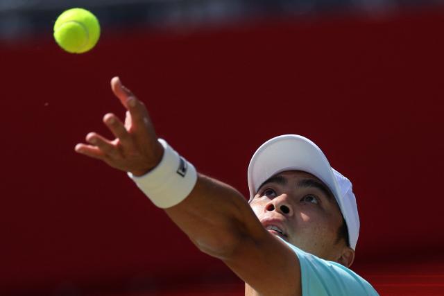 Brandon Nakashima of the US serves against Peru's Ignacio Buse during their men's singles round of 16 tennis match on day three of the ATP HSBC Championships at Queen's Club in west London on June 17, 2026. (Photo by Adrian Dennis / AFP)