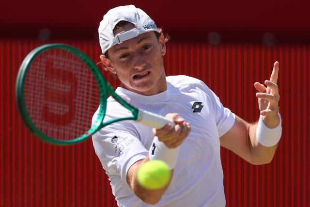 Peru's Ignacio Buse hits a return against Brandon Nakashima of the US during their men's singles round of 16 tennis match on day three of the ATP HSBC Championships at Queen's Club in west London on June 17, 2026. (Photo by Adrian Dennis / AFP)