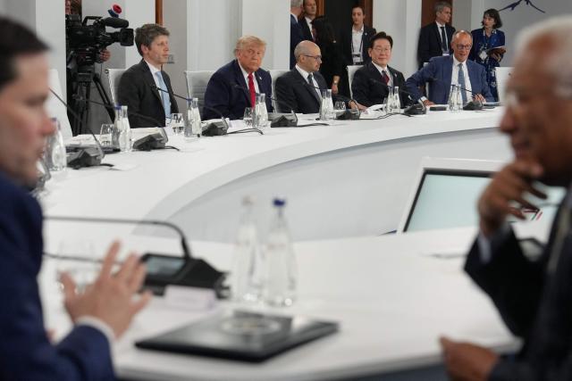 US President Donald Trump (Top 2ndL) reacts next to Open AI CEO Sam Altman and Google DeepMind Demis Hassabis, South Korea's President Lee Jae-myung and Germanys Chancellor Friedrich Merz as US Secretary of State Marco Rubio (L) and European Council President Antonio Costa (R) talk in the foreground during a working lunch meeting of G7 members, partner countries, and artificial intelligence business leaders as part of the G7 summit, in Evian, eastern France, on June 17, 2026. A G7 summit is set to take place June 15 to 17 in the French town of Evian-les-Bains near Switzerland and it will be attended by country leaders as well as the EU's foreign policy chief and ministers from Brazil, Canada, the United Arab Emirates and Turkey. (Photo by Julia Demaree Nikhinson / POOL / AFP)