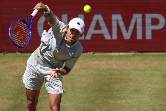 Australia's Alex de Minaur serves against Canada's Denis Shapovalov during their men's singles round of 16 tennis match on day three of the ATP HSBC Championships at Queen's Club in west London on June 17, 2026. (Photo by Adrian DENNIS / AFP)