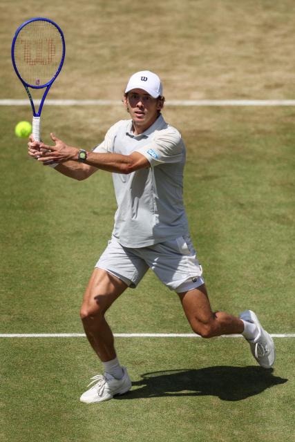 Australia's Alex de Minaur eyes a return volley against Canada's Denis Shapovalov during their men's singles round of 16 tennis match on day three of the ATP HSBC Championships at Queen's Club in west London on June 17, 2026. (Photo by Adrian DENNIS / AFP)