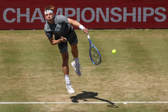 Canada's Denis Shapovalov serves against Australia's Alex de Minaur during their men's singles round of 16 tennis match on day three of the ATP HSBC Championships at Queen's Club in west London on June 17, 2026. (Photo by Adrian DENNIS / AFP)
