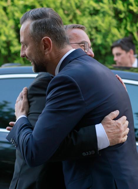 German Defence Minister Boris Pistorius (back) is welcomed by Poland's Deputy Prime Minister and Minister of National Defence Wladyslaw Kosiniak-Kamysz on June 17, 2026 in Warsaw, Poland. The two ministers are to sign a bilateral agreement on Polish-German defence cooperation. (Photo by Wojtek RADWANSKI / AFP)