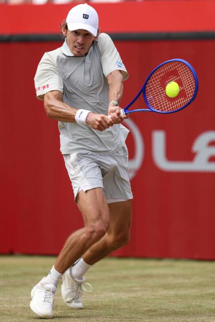 Australia's Alex de Minaur hits a return Canada's Denis Shapovalov during their men's singles round of 16 tennis match on day three of the ATP HSBC Championships at Queen's Club in west London on June 17, 2026. (Photo by Adrian DENNIS / AFP)