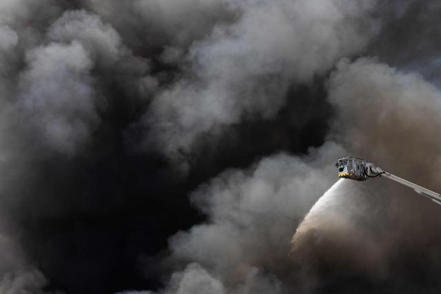 Firefighters work to extinguish a fire at an industrial facility in Bobigny, north of Paris, on June 17, 2026. (Photo by JOEL SAGET / AFP)
