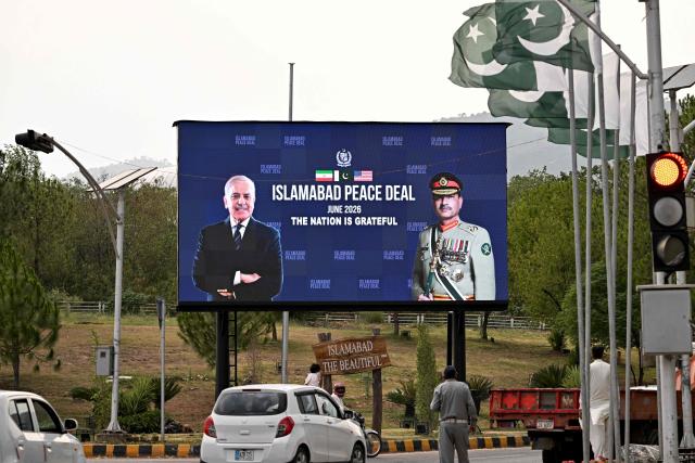 Commuters ride past an electronic board featuring Pakistan's Prime Minister Shehbaz Sharif (L) with Army Chief and Field Marshal Syed Asim Munir, displayed along a roadside in Islamabad on June 17, 2026, after the US–Iran peace deal announcement. Top officials from the United States and Iran will meet at a luxury mountainside resort in Switzerland on June 19, to sign a deal -- which Pakistan has helped mediate -- to bring the Middle East war to an end. (Photo by Aamir QURESHI / AFP)