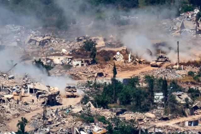 This picture taken from a position in the Upper Galilee in northern Israel, near the Israel-Lebanon border shows Israeli Merkava tanks driving along a road past destroyed buildings in southern Lebanon on June 17, 2026. Lebanon and Israel have been holding direct talks in Washington since April, seeking to end the hostilities between Israel and Hezbollah and separate their conflict from the wider regional war. (Photo by JACK GUEZ / AFP)