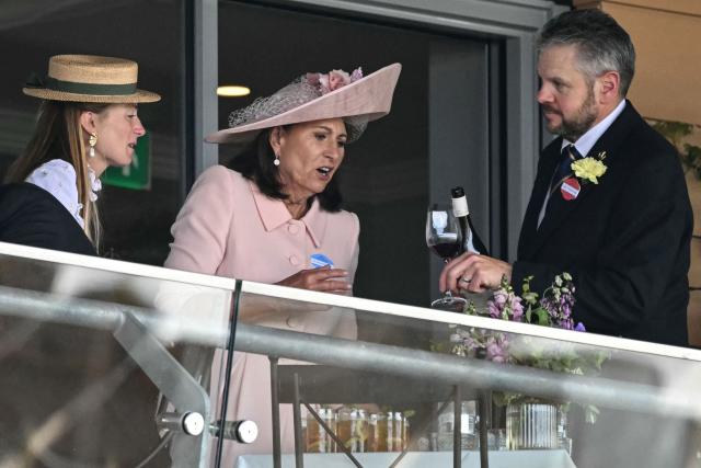 Carole Middleton (C), the mother of Britain's Catherine, Princess of Wales, has a drink at one of the boxes on the second day of the Royal Ascot horse racing meeting in Ascot, west of London, on June 17, 2026. (Photo by JUSTIN TALLIS / AFP)