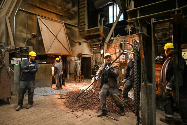 Employees work at the electric arc furnace (EAF) to melt down scrap metal at KNDS Deutschland Tracks GmbH during a visit as part of the Cleantech Future Festival in Remscheid, western germany on June 17, 2026. KNDS Deutschland Tracks GmbH is a global leader in the development and manufacture of tracks and undercarriage components for tanks and armoured vehicles. The international Future Cleantech Festival brings together high-level UN climate policy and research with practical insights into European heavy industry (Photo by Ina FASSBENDER / AFP)