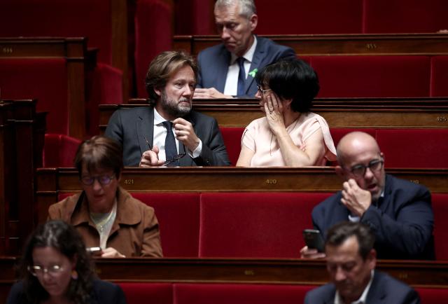 President of Socialistes et Apparentes parliamentary group Boris Vallaud (L, second row) speaks with Socialistes et Apparentes' MP Christine Pires Beaune during a session of questions to the government at The National Assembly, France's lower house of parliament in Paris on June 17, 2026. (Photo by Guillaume BAPTISTE / AFP)
