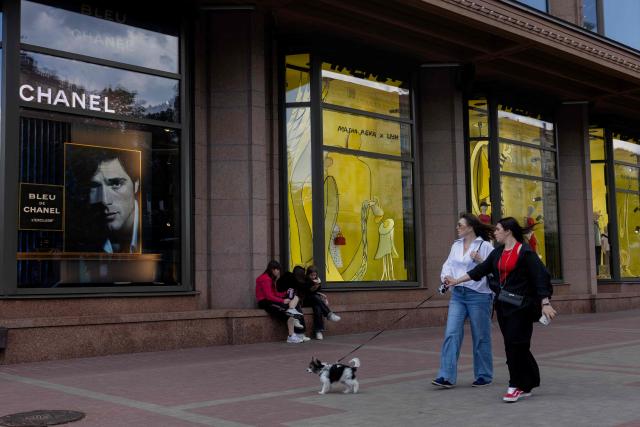 Girls walk a dog in Kyiv on June 17, 2026, amid the Russian invasion of Ukraine. (Photo by Tetiana DZHAFAROVA / AFP)