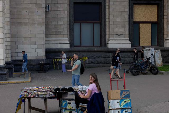 People walk down a street in Kyiv on June 17, 2026, amid the Russian invasion of Ukraine. (Photo by Tetiana DZHAFAROVA / AFP)