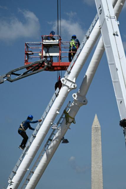 A Ferris wheel is being assembled as preparations continue for the "Great American State Fair" on the National Mall in Washington, DC, June 17, 2026. The "Great American State Fair" will be held from June 25 to July 10, 2026, to celebrate the 250th anniversary of US independence. (Photo by Brendan SMIALOWSKI / AFP)