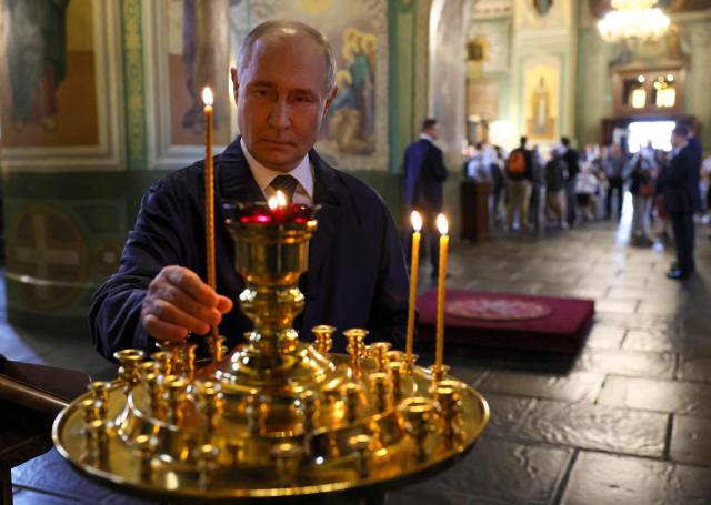 In this pool photograph distributed by the Russian state agency Sputnik, Russia's President Vladimir Putin visits the Annunciation Cathedral in the Kazan Kremlin in Kazan on June 17, 2026. (Photo by Mikhail METZEL / POOL / AFP)