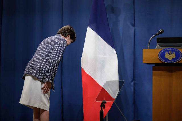 TOPSHOT - Japan's Prime Minister Sanae Takaichi salutes the French flag as she leaves the stage after a press conference of the G7 summit, in Evian, eastern France, on June 17, 2026. A G7 summit is set to take place June 15 to 17 in the French town of Evian-les-Bains near Switzerland and it will be attended by country leaders as well as the EU's foreign policy chief and ministers from Brazil, Canada, the United Arab Emirates and Turkey. (Photo by Fabrice COFFRINI / AFP)