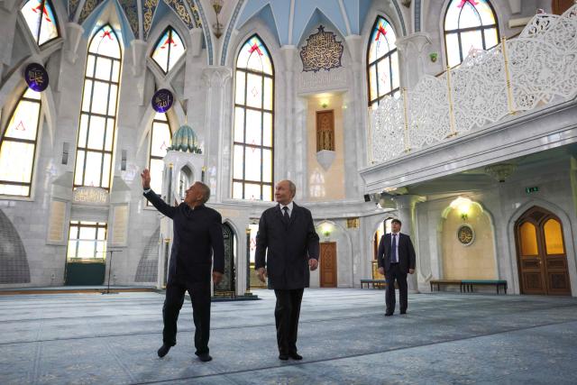 In this pool photograph distributed by the Russian state agency Sputnik, Russia's President Vladimir Putin, accompanied by Head of Republic of Tatarstan Rustam Minnikhanov, visits the Kul-Sharif mosque in the Kazan Kremlin in Kazan on June 17, 2026. (Photo by Mikhail METZEL / POOL / AFP)