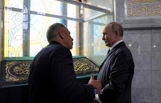 In this pool photograph distributed by the Russian state agency Sputnik, Russia's President Vladimir Putin, accompanied by Head of Republic of Tatarstan Rustam Minnikhanov, visits the Kul-Sharif mosque in the Kazan Kremlin in Kazan on June 17, 2026. (Photo by Mikhail METZEL / POOL / AFP)