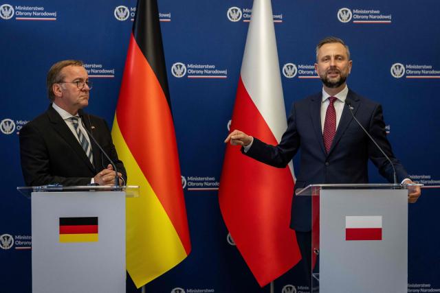 Poland's Deputy Prime Minister and Defence Minister Wladyslaw Kosiniak-Kamysz (R) and Germany's Defence Minister Boris Pistorius (L) address a join press conference after signing a defence agreement between Poland and Germany at the Defence Ministry building in Warsaw, Poland, on June 17, 2026. (Photo by Wojtek RADWANSKI / AFP)