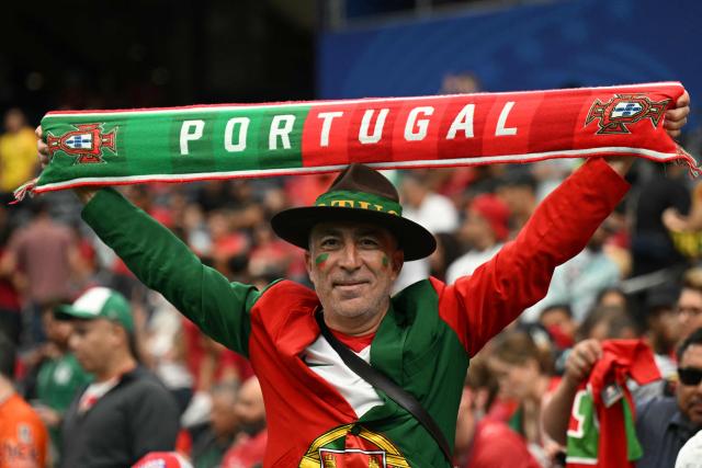 A Portugal supporter poses with a scarf  in the tribunes prior to the 2026 World Cup Group K football match between Portugal and the Democratic Republic of Congo at the Houston Stadium in Houston on June 17, 2026.  (Photo by RONALDO SCHEMIDT / AFP)