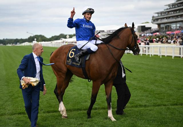 Jockey William Buick celebrates riding Ombudsman to win the Prince Of Wales's Stakes horse race on the second day of the Royal Ascot horse racing meeting in Ascot, west of London, on June 17, 2026. (Photo by JUSTIN TALLIS / AFP)